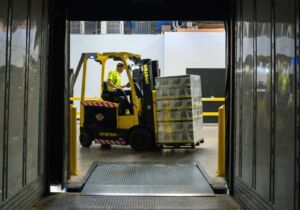 A forklift removes items from a storage unit