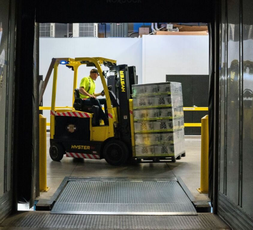 A forklift removes items from a storage unit